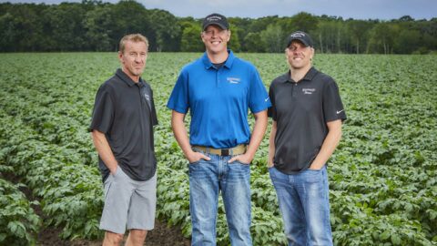 Wingard Farms' fourth generation standing in front of potato field