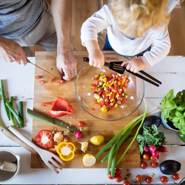 Young father with a toddler boy cooking.